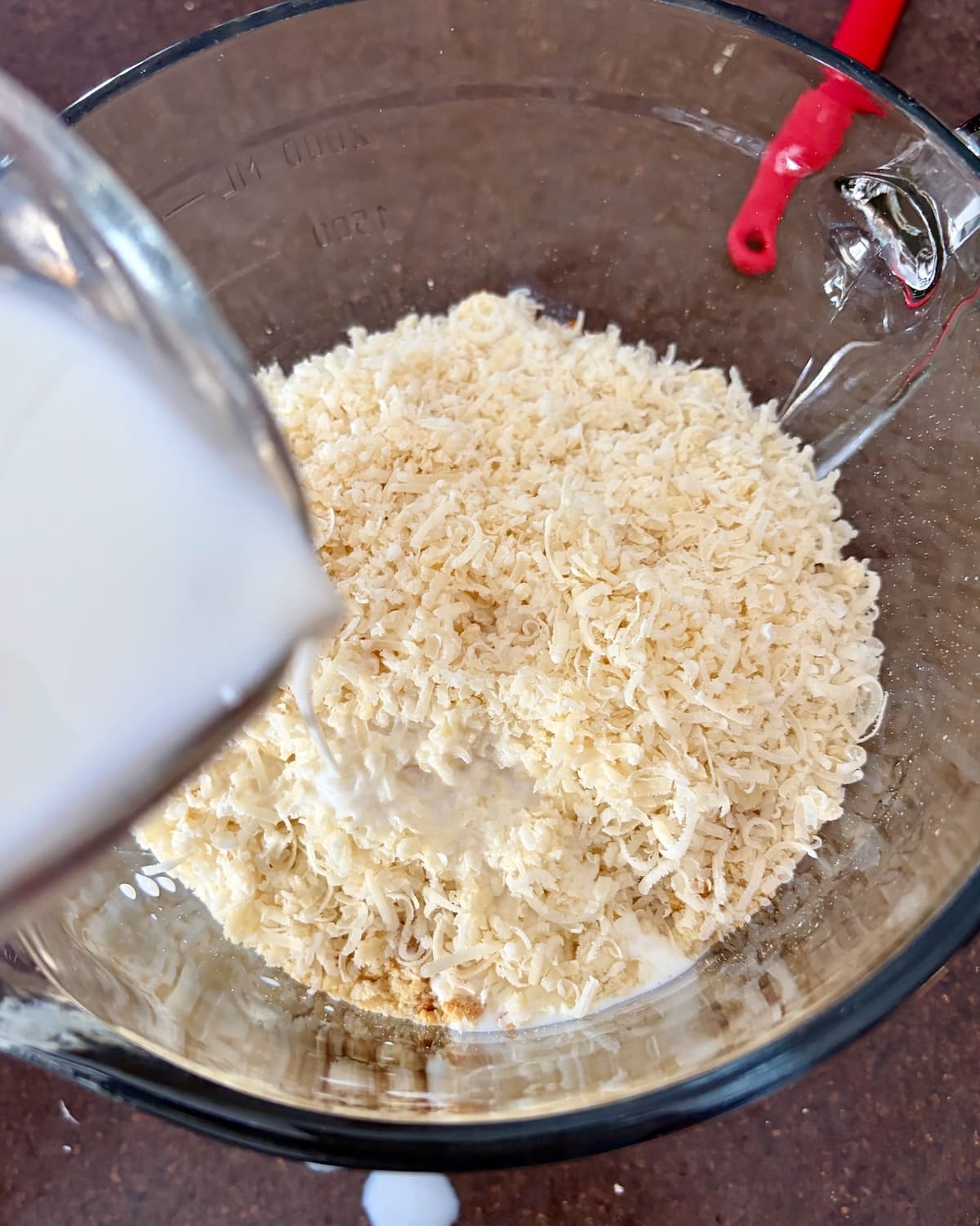 Photo adding the milk to the breadcrumbs and parmesan