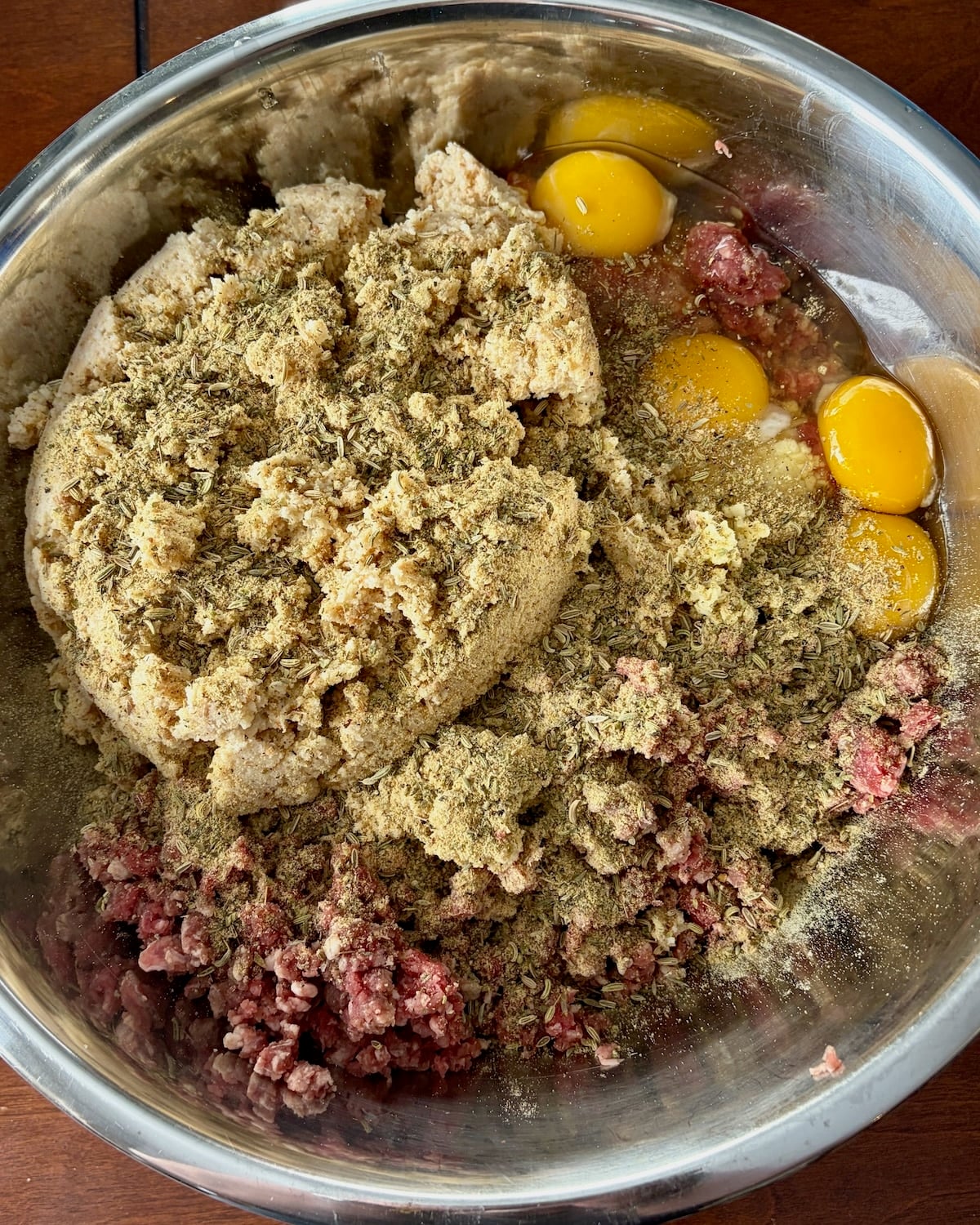 All the ingredients for mini meatballs in a large metal bowl.