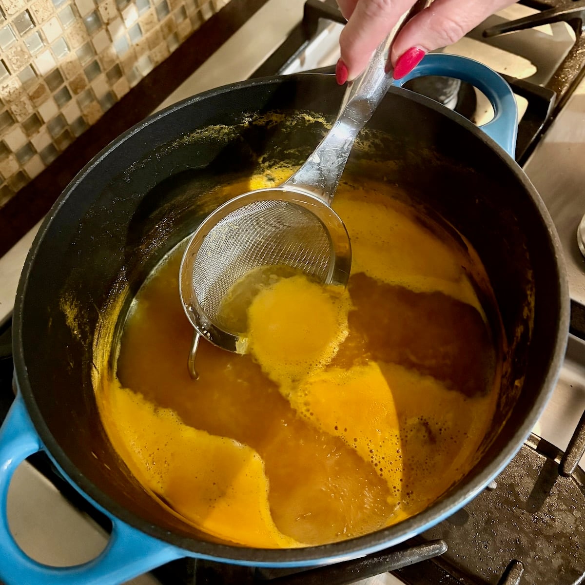 Homemade Orange Juice Concentrate photo of skimming foam from the surface