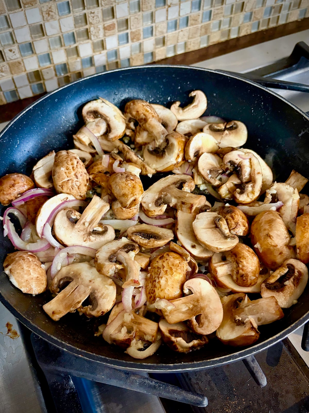 Mushrooms Onions and garlic in a saute pan.
