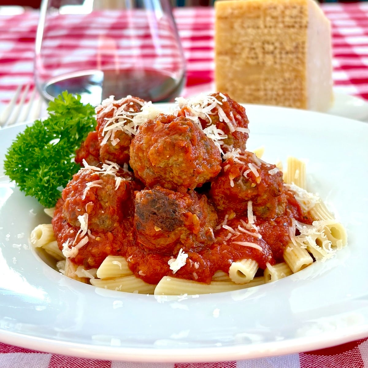 Mini Meatballs in tomato sauce with penne pasta for featured google image.