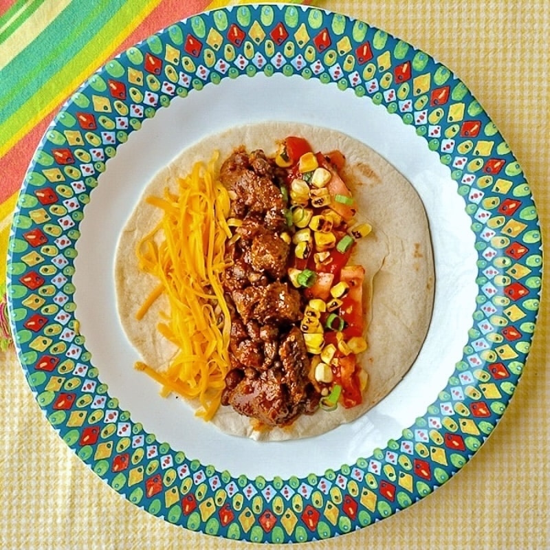Beef Tacos From the Slow Cooke single taco on multicoloured plate