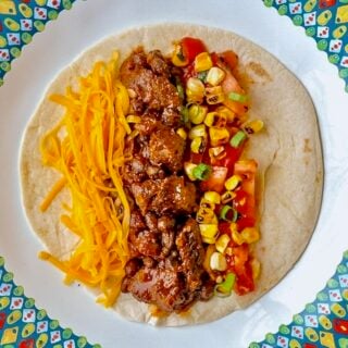 Beef Tacos From the Slow Cooker close up of single serving with grilled corn salsa