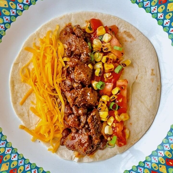 Beef Tacos From the Slow Cooker close up of single serving with grilled corn salsa