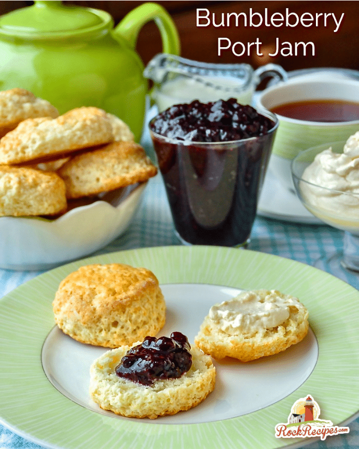 Bumbleberry Port Jam photo of jam with scones and cream with title text added for social media posts.