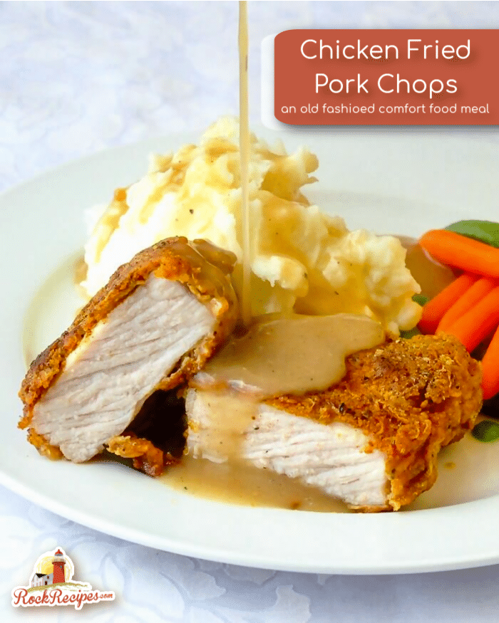 Chicken Fried Pork Chops photo of one serving in a white plate with gravy being poured on with title text added for social media posts.