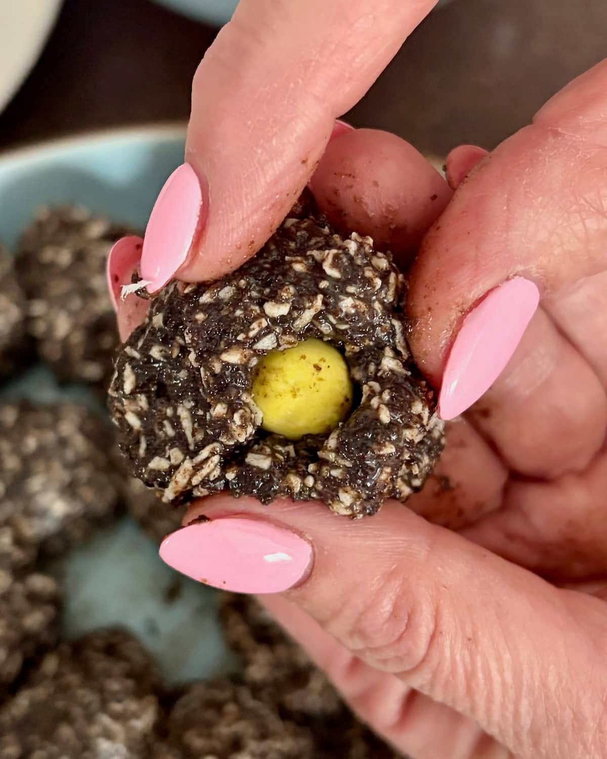 Surrounding the mini egg with the finished cookie mixture.