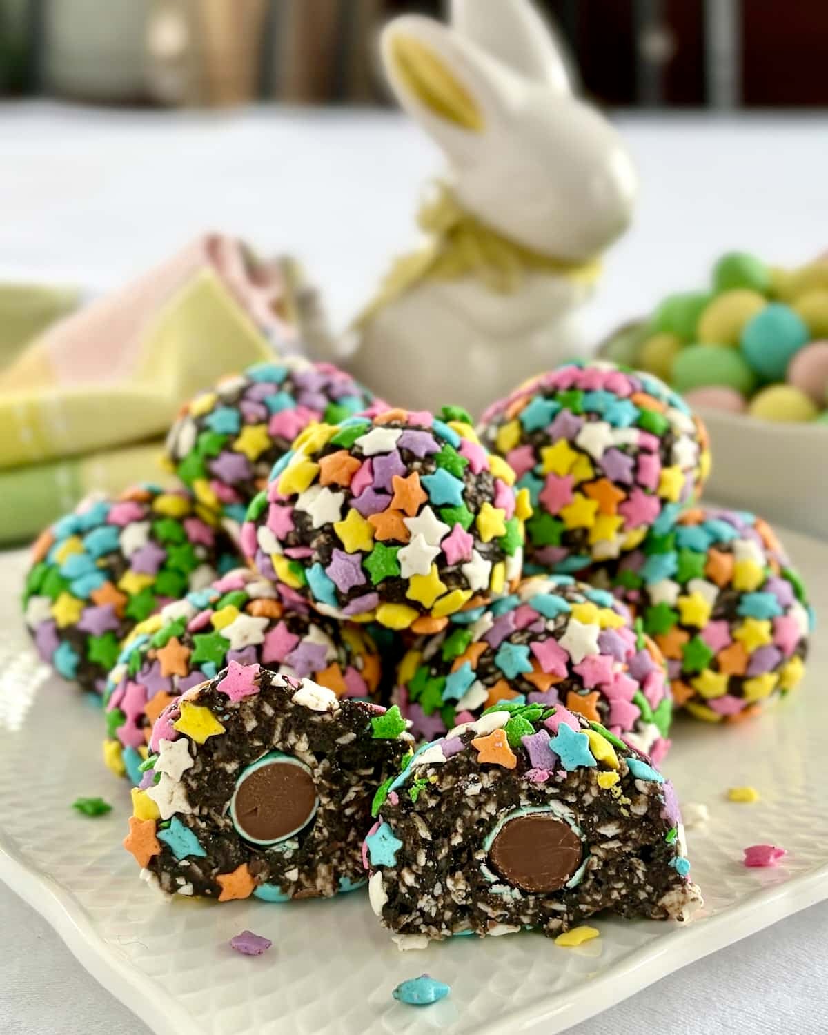 Photo of centre cut Easter Bunny Farts stacked on a white plate. with mini eggs in background.
