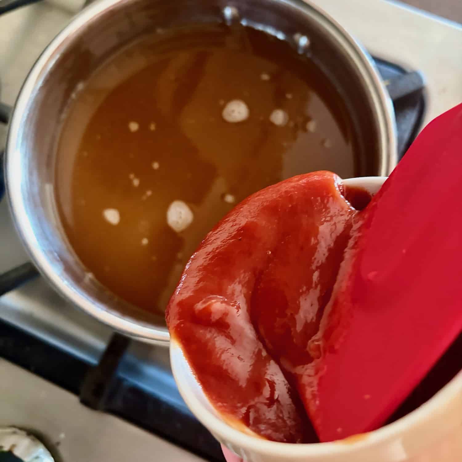 Photo of Ketchup being added to the sauce