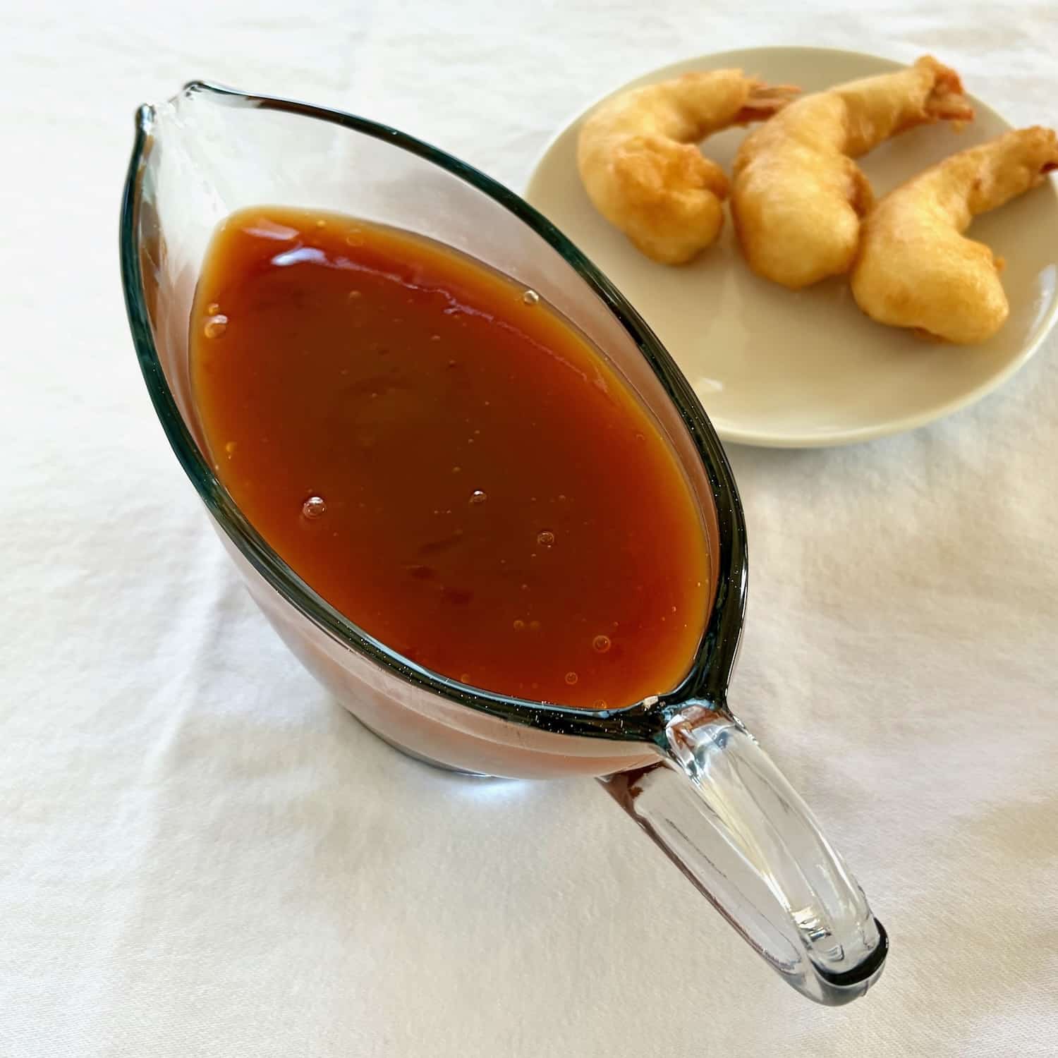 Overhead photo of sweet and sour sauce with batt.ered shrimp