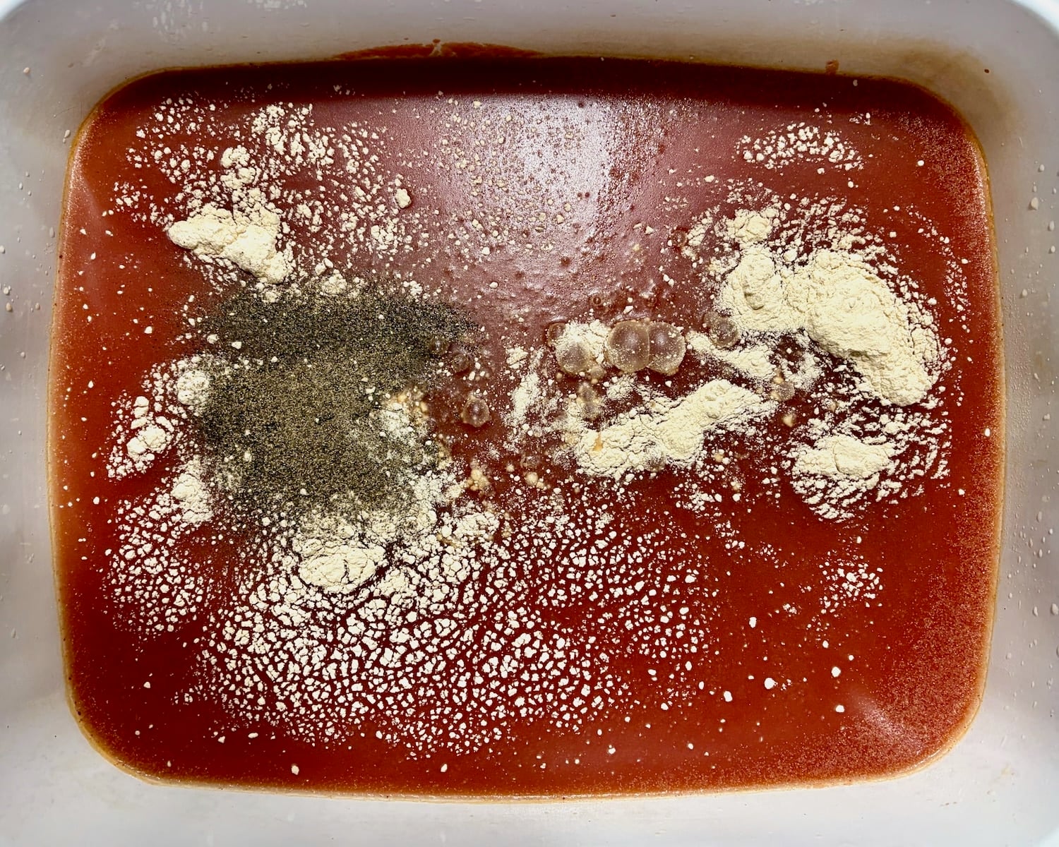 Photo oo spices being added to the sauce for Beans and Weiners