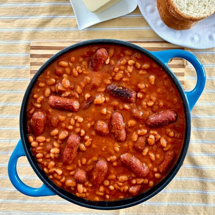 Close up overhead shot of a dutch oven containing the finished Beans and Weiners.