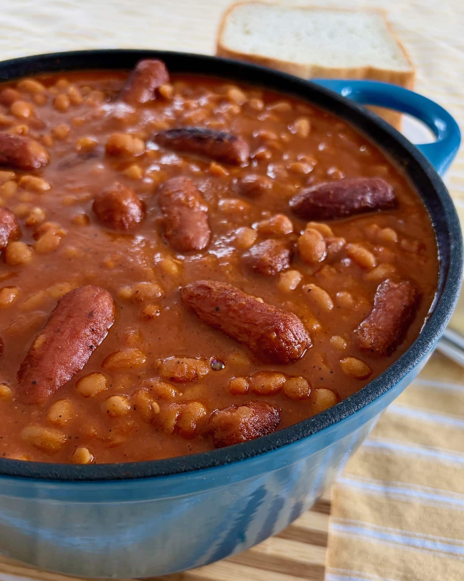 lose up photo of a cooked pot of Overhead shot of a dutch oven containing the finished Beans and Weiners.