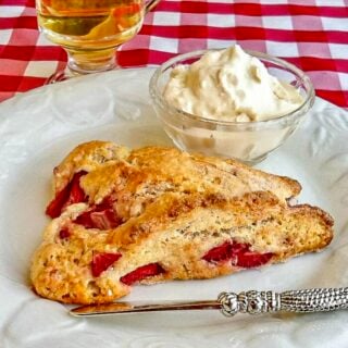 Strawberry Shortcake Scones shown on white plate with clotted cream