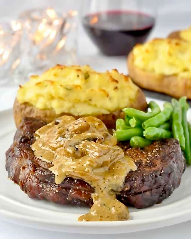 Bourbon Mushroom Sauce on Grilled Rib Eye Steak with green beans and twice baked potatoes