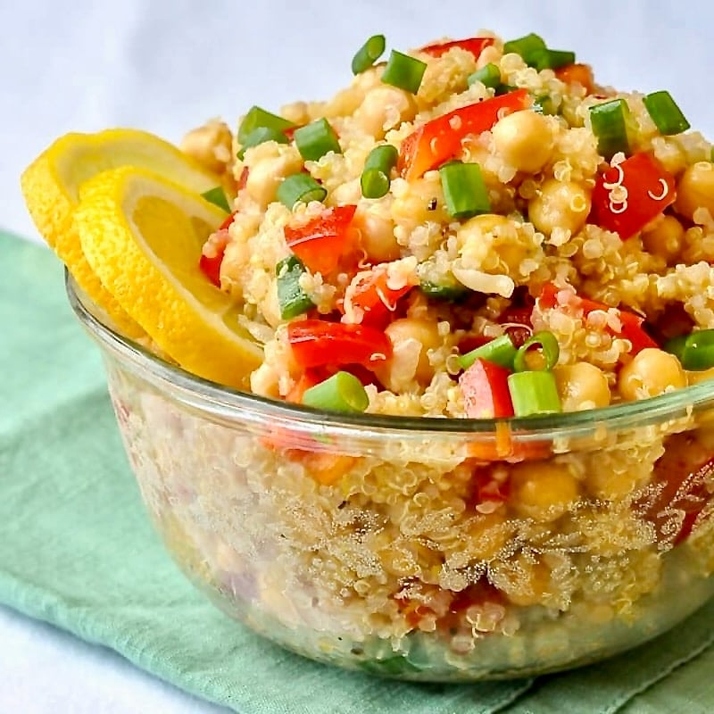 Chickpea Salad with Quinoa Lemon and Ginger shown served in a clear glass bowl.