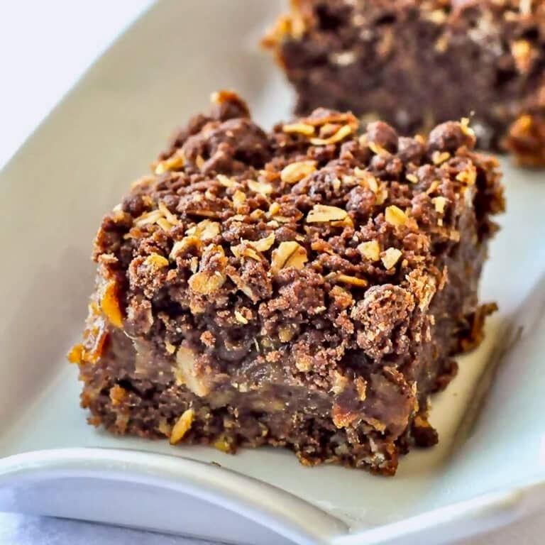 Chocolate Orange Date Crumbles close up photo of one cookie square on a white platter