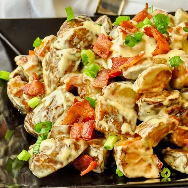 Creamy Bacon Parmesan Potatoes close up photo on black serving platter