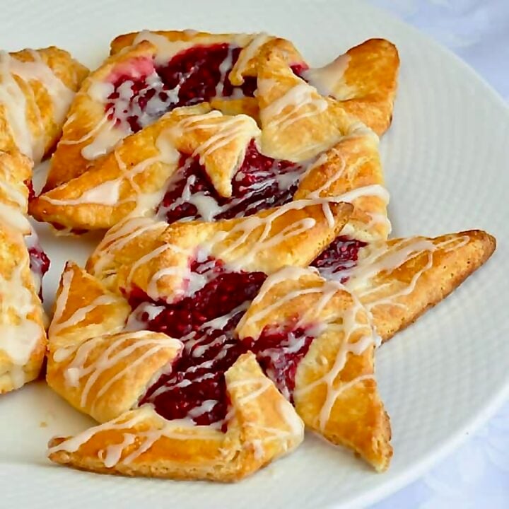 Several pinwheel Danish in a white plate.
