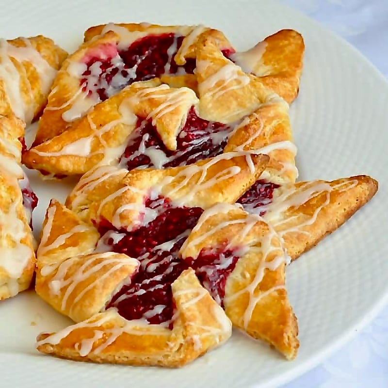 Several pinwheel Danish in a white plate.