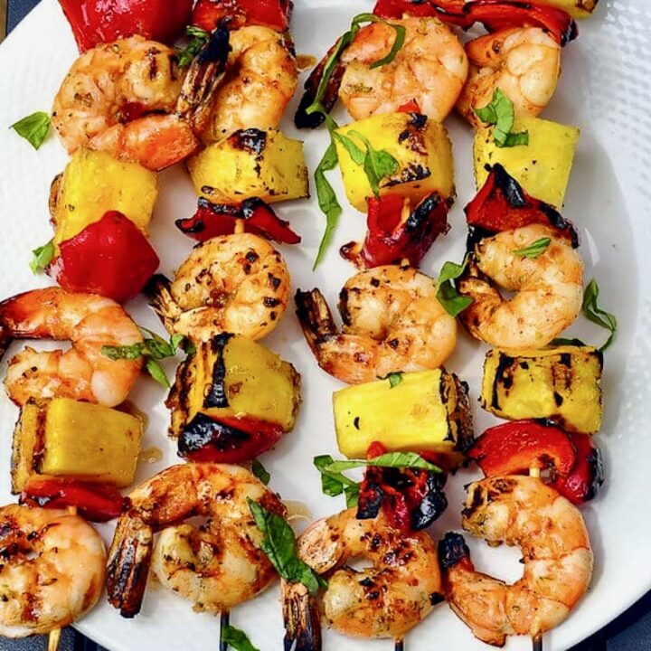Close up photo of skewers of cooked Chili Lime Shrimp Kabobs.