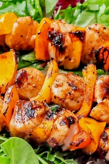 Ginger Soy Grilled Scallops close up photo on a bed of fresh lettuce