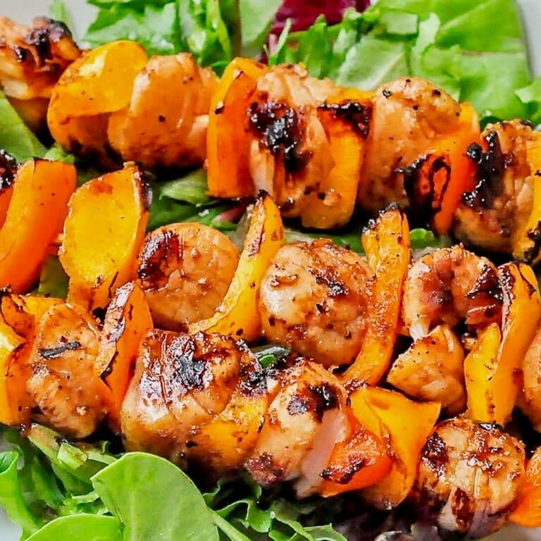 Ginger Soy Grilled Scallops close up photo on a bed of fresh lettuce