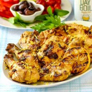 Grilled Lemon Chicken close up photo of cooked chicken on a white platter