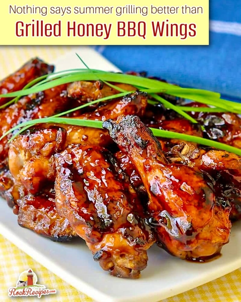 Grilled Honey Barbecue Wings close up photo of stacked wings with title text added for social media.