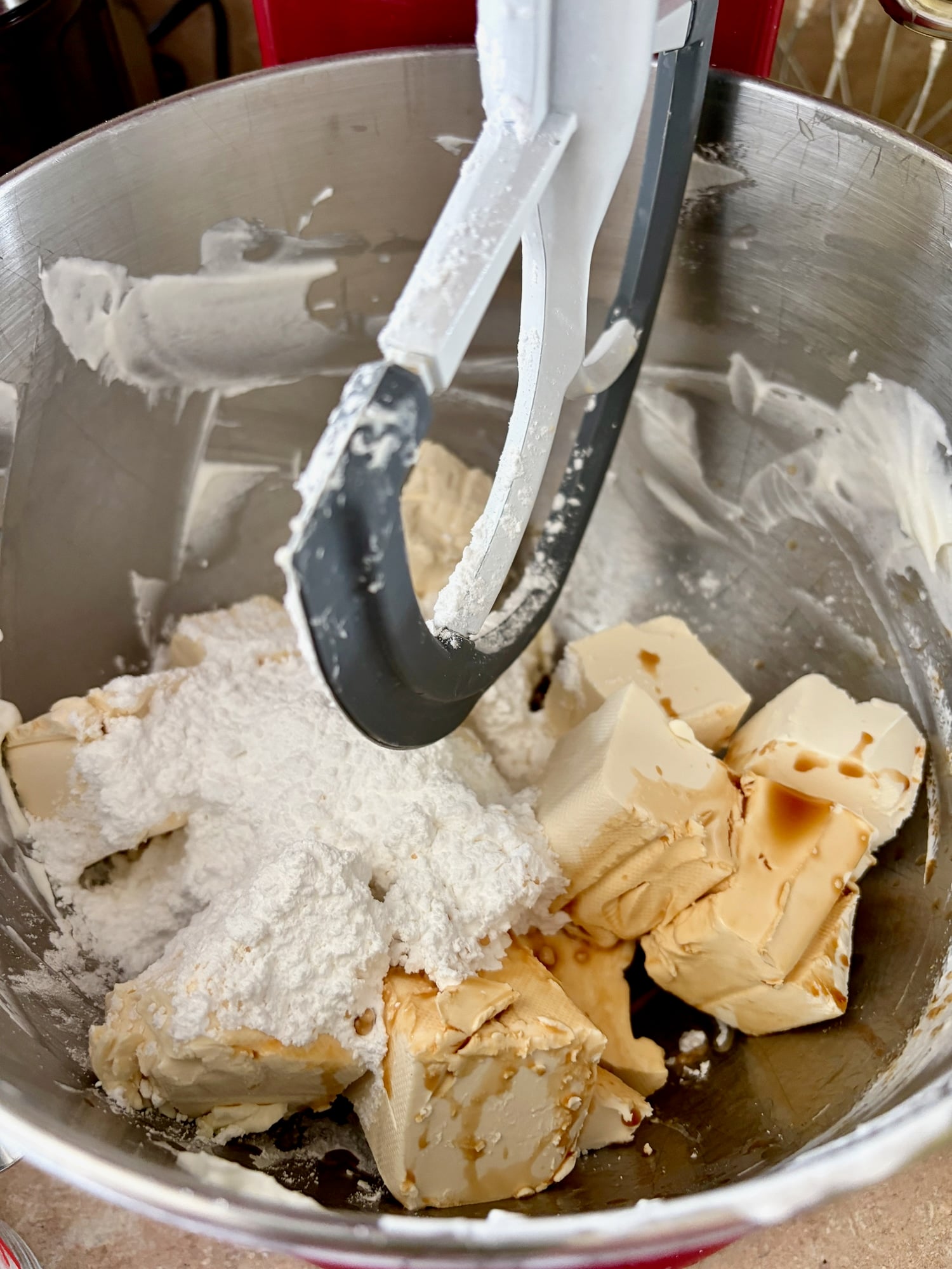 photo of Adding the cream cheese icing sugar and vanilla to the mixer bowl.