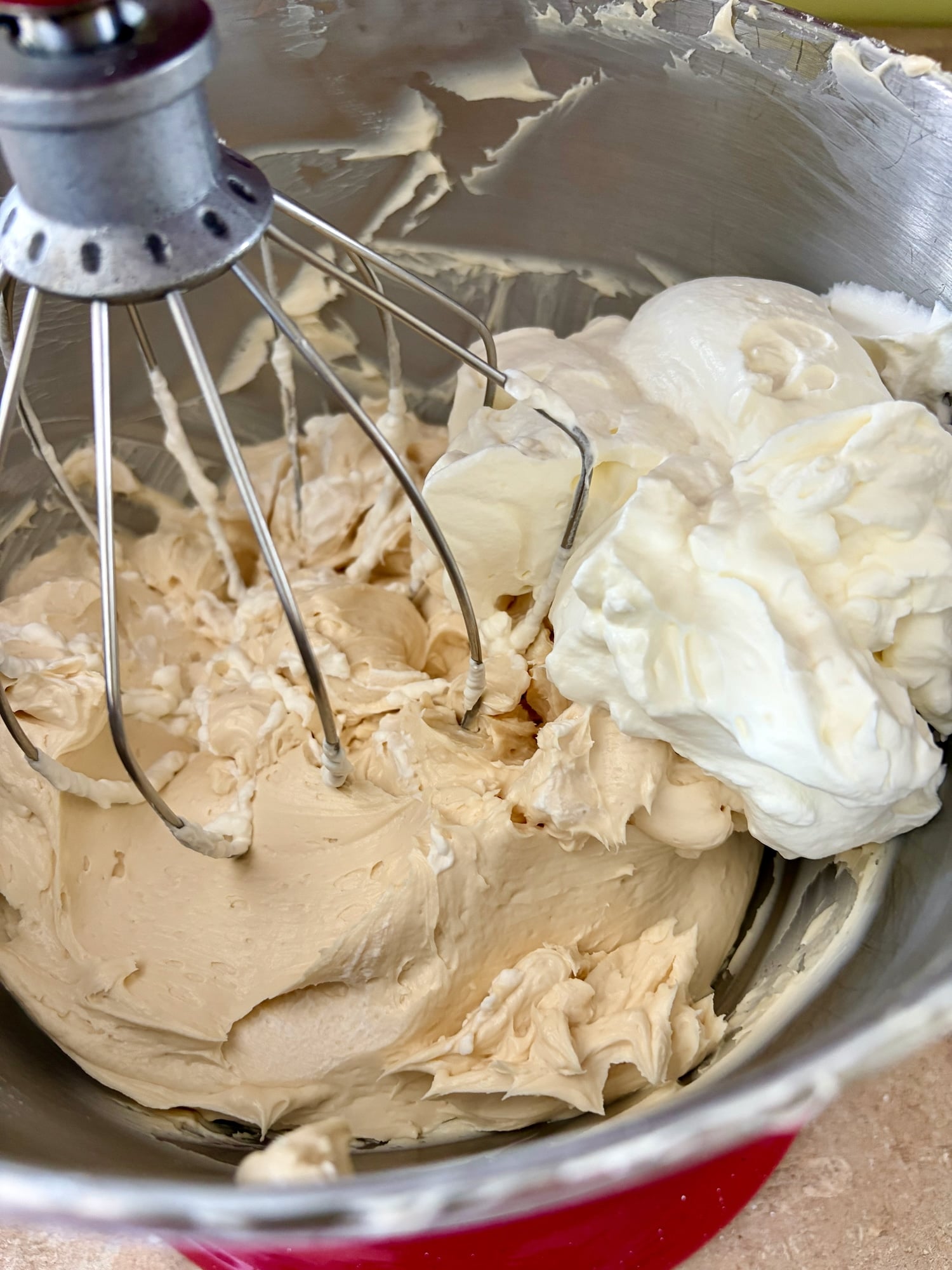 Switch ti the whisk attachment again and begin incorporating the whipped cream into the cheesecake mixture.