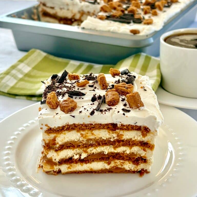 Biscoff Butterscotch Cheesecake Tiramisu close up photo of one serving on a white plate for Google featured image.