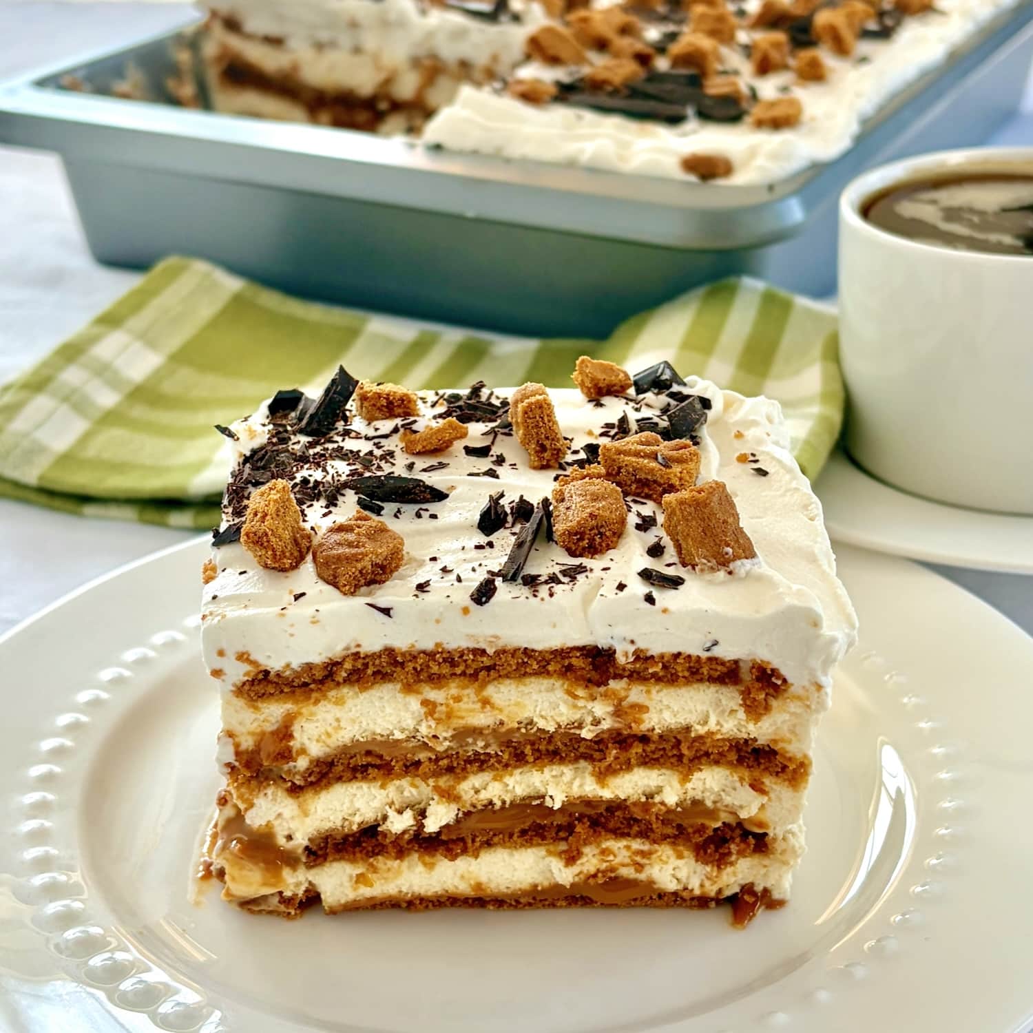 Biscoff Butterscotch Cheesecake Tiramisu close up photo of one serving on a white plate for Google featured image.
