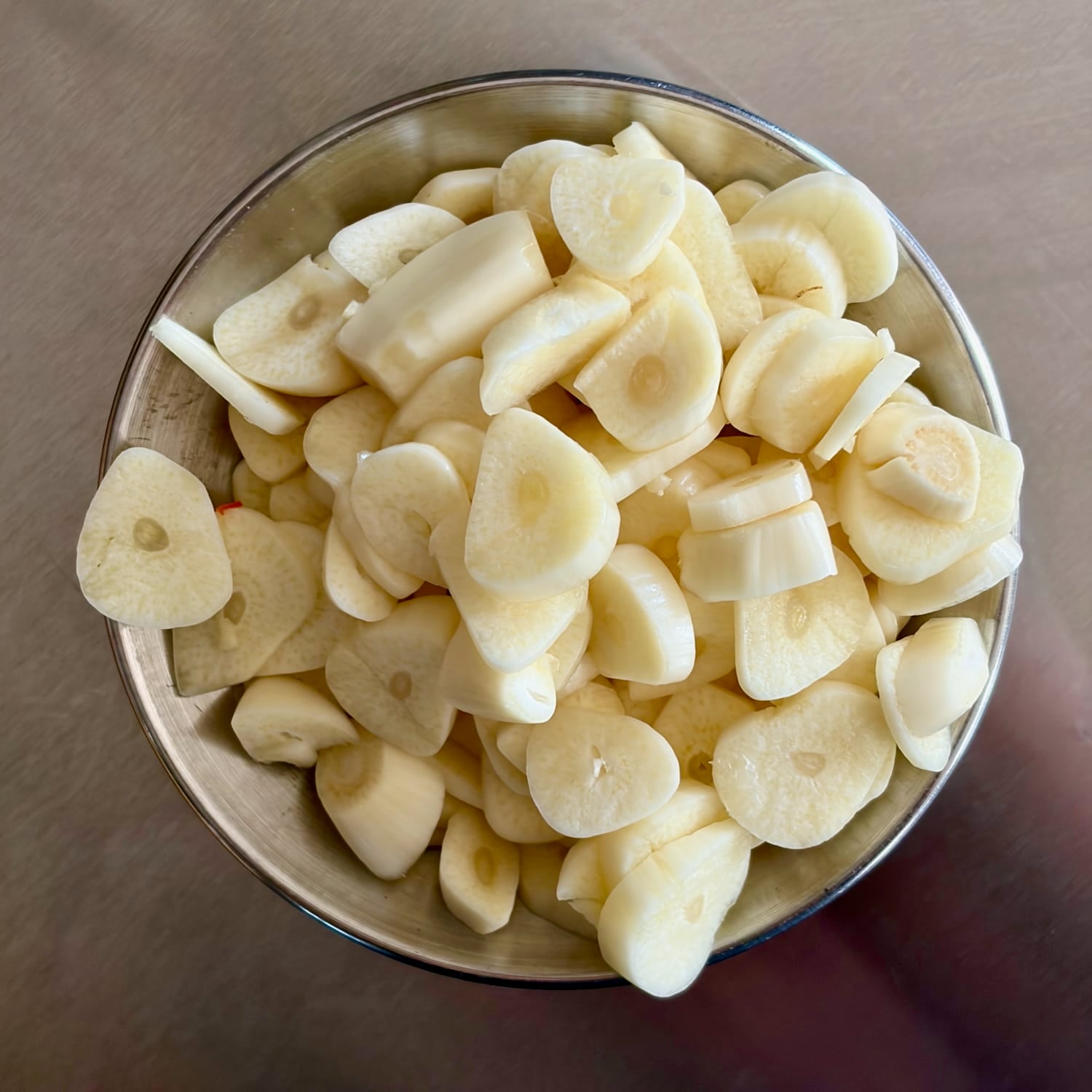 photo of uncooked peeled and sliced garlic 
