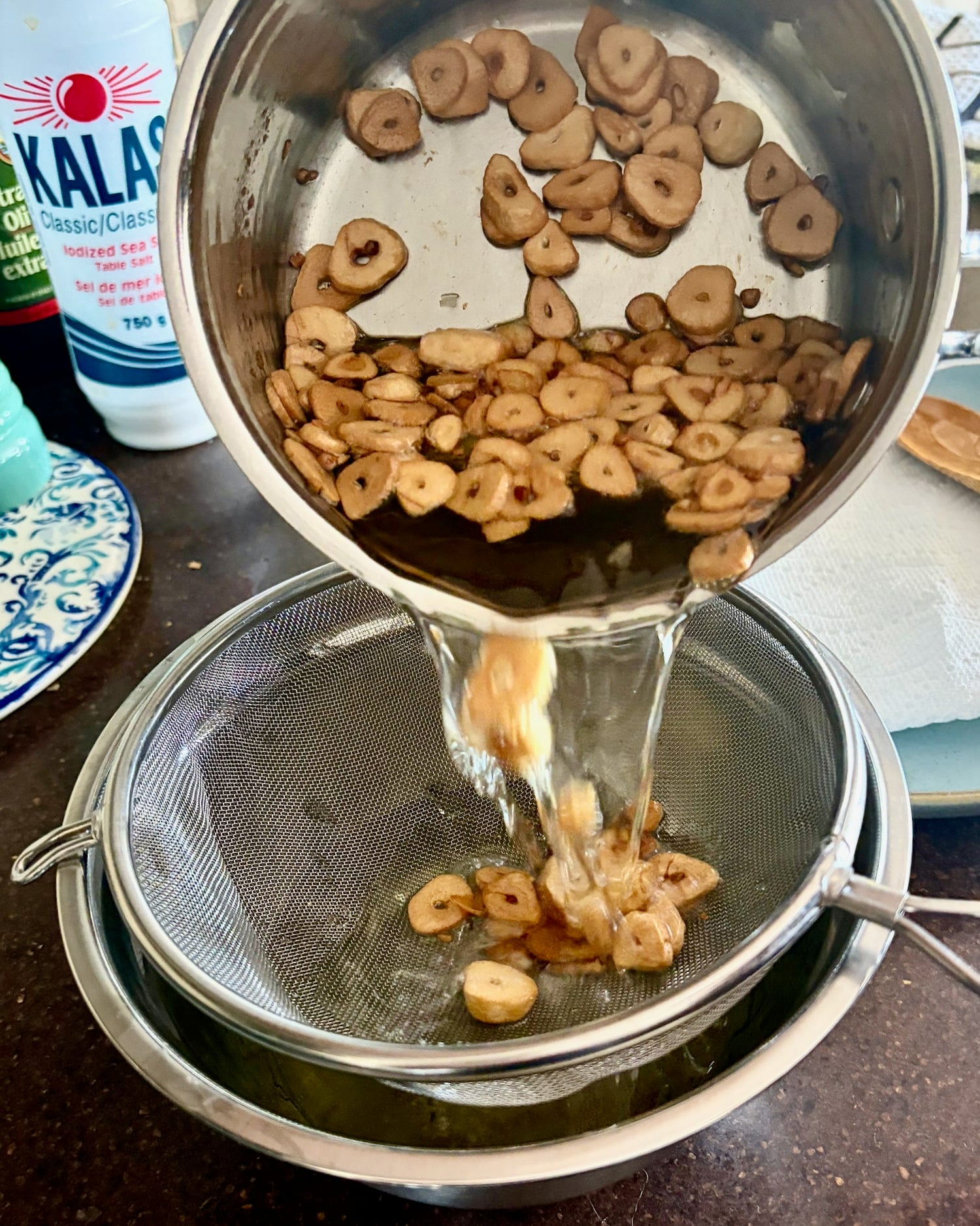 straining the garlic from the oil