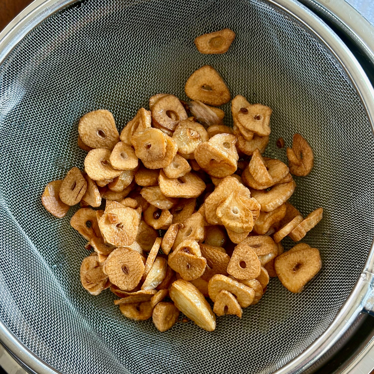 photo of crispy garlic in a sieve