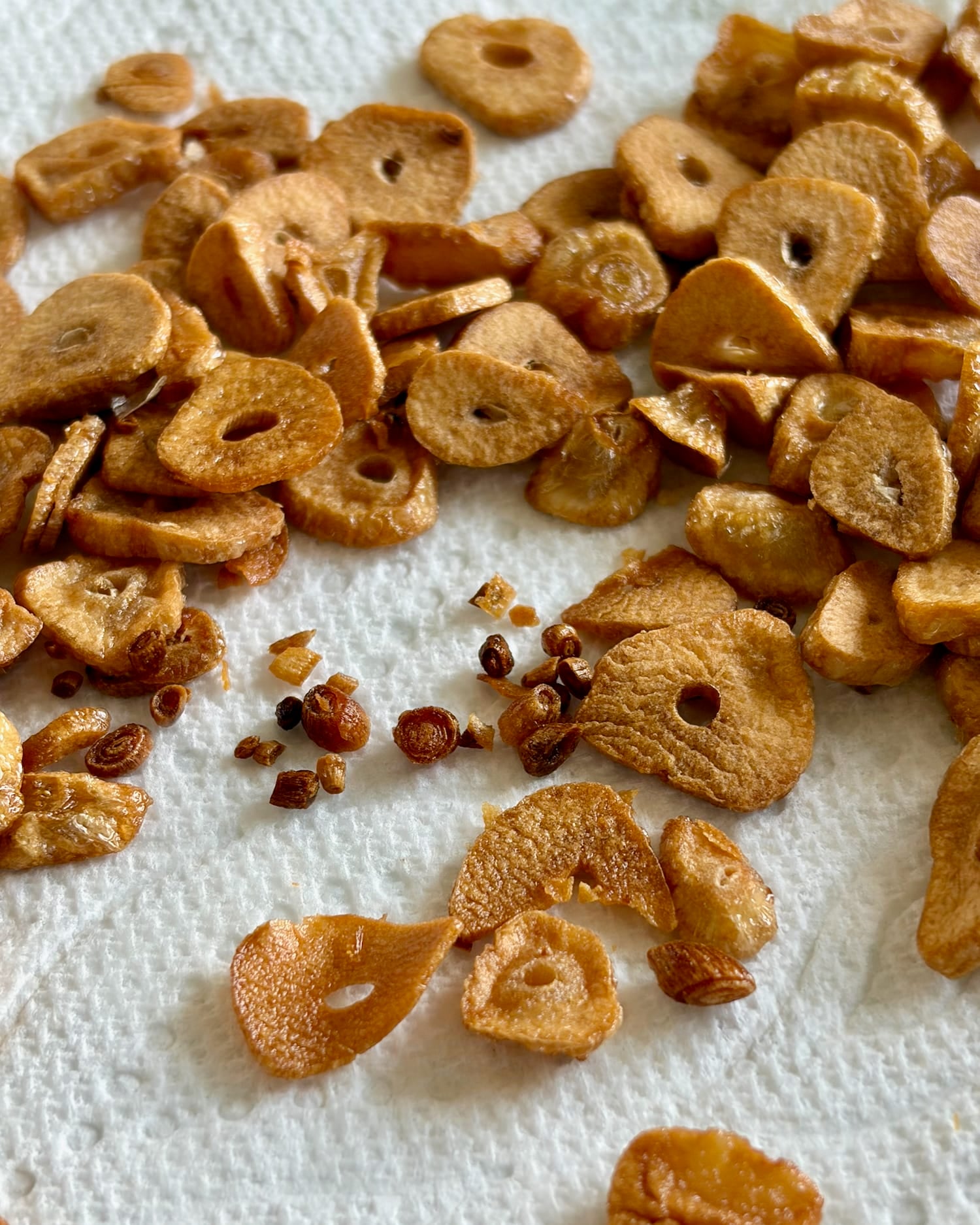 close up photo of fried garlic on paper towels.