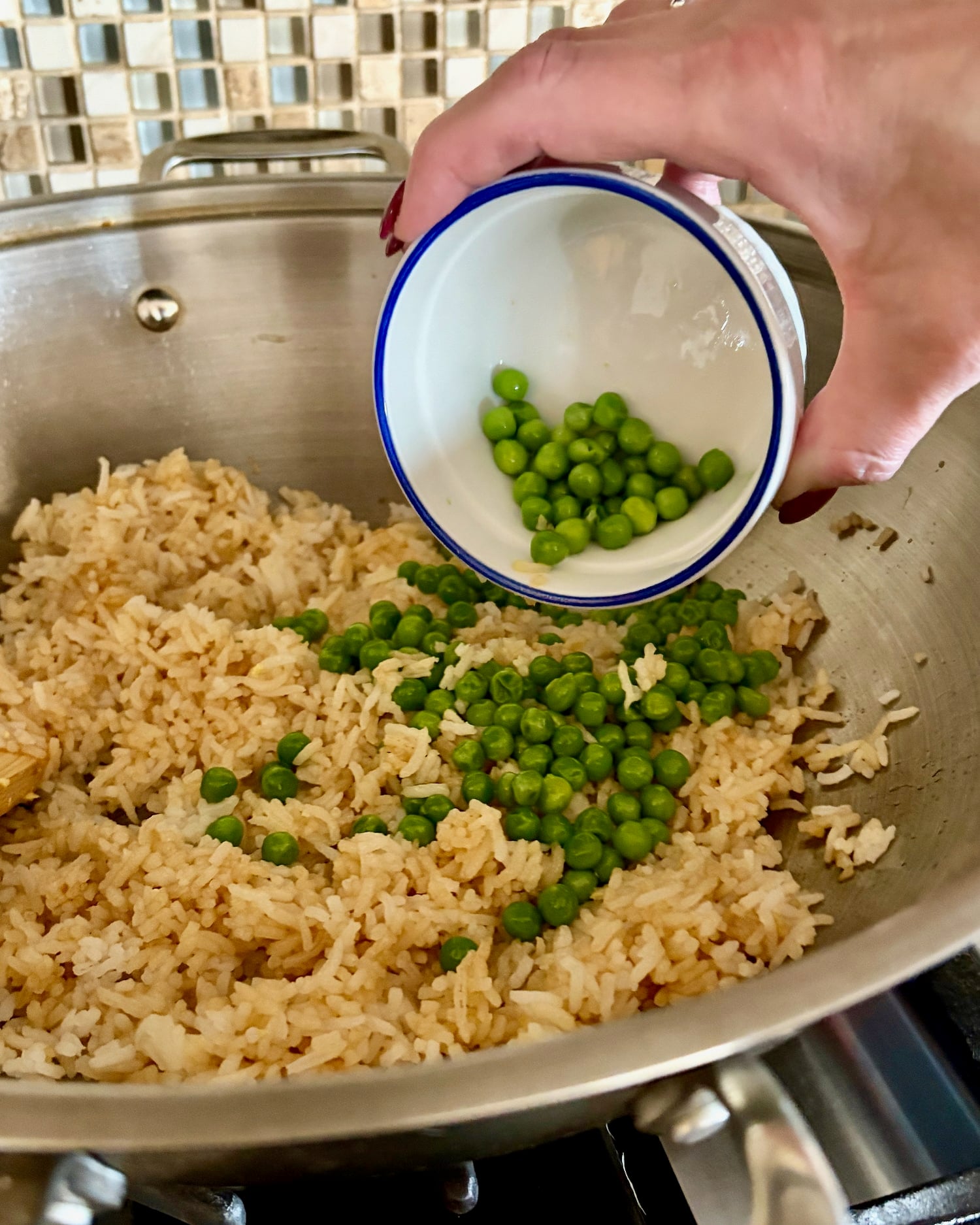 green peas being added to Egg Fried Rice