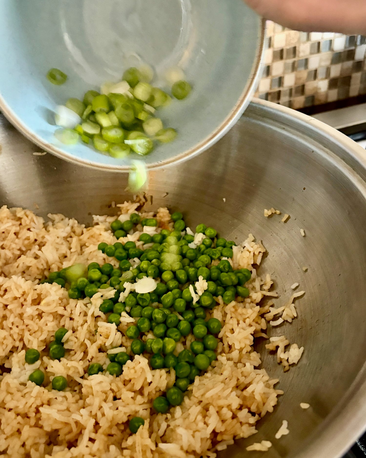 green onions being added to Egg Fried Rice
