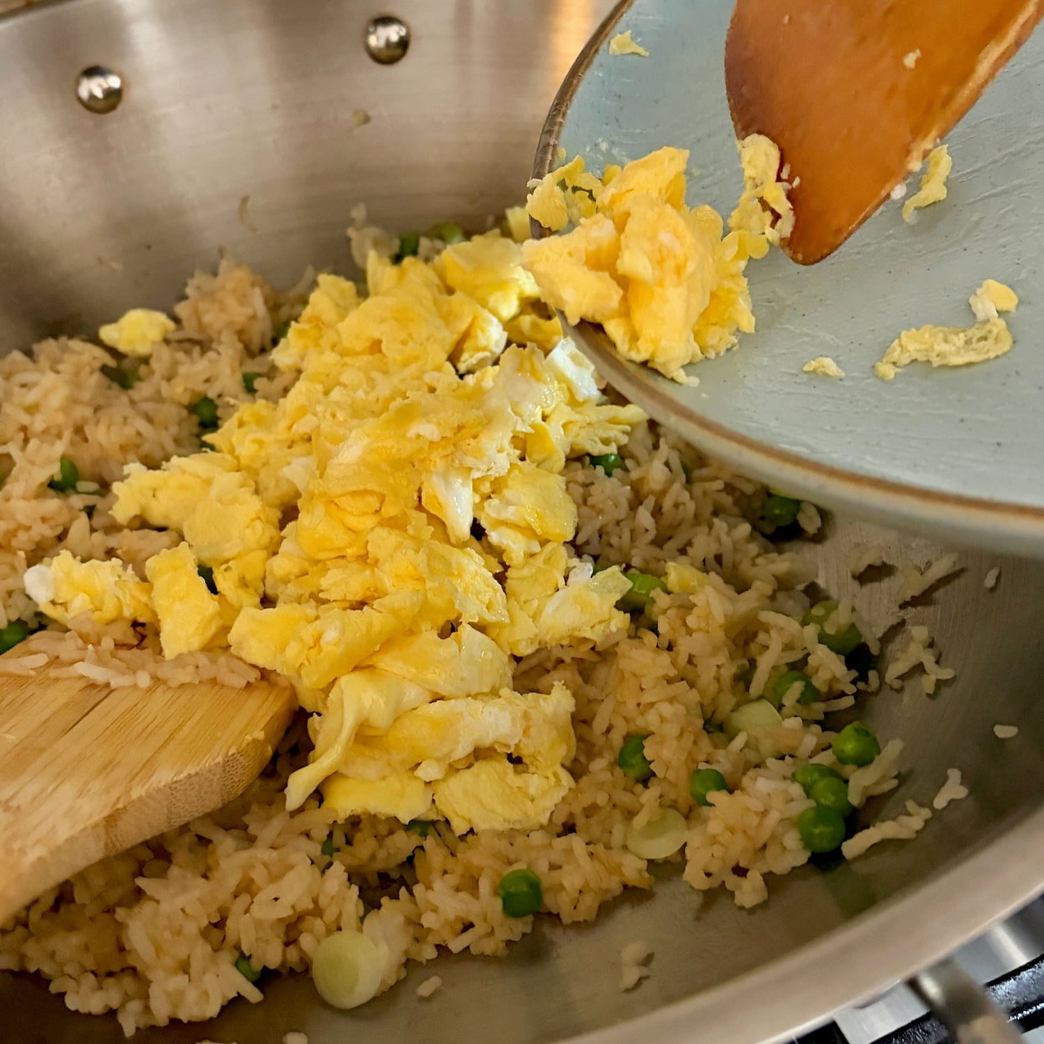 scrambled egg being added to Egg Fried Rice