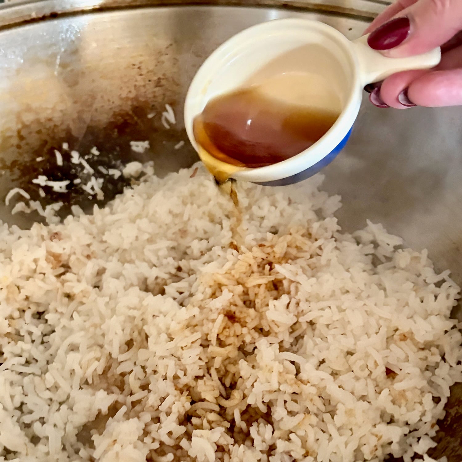 fish sauce being added to Egg Fried Rice
