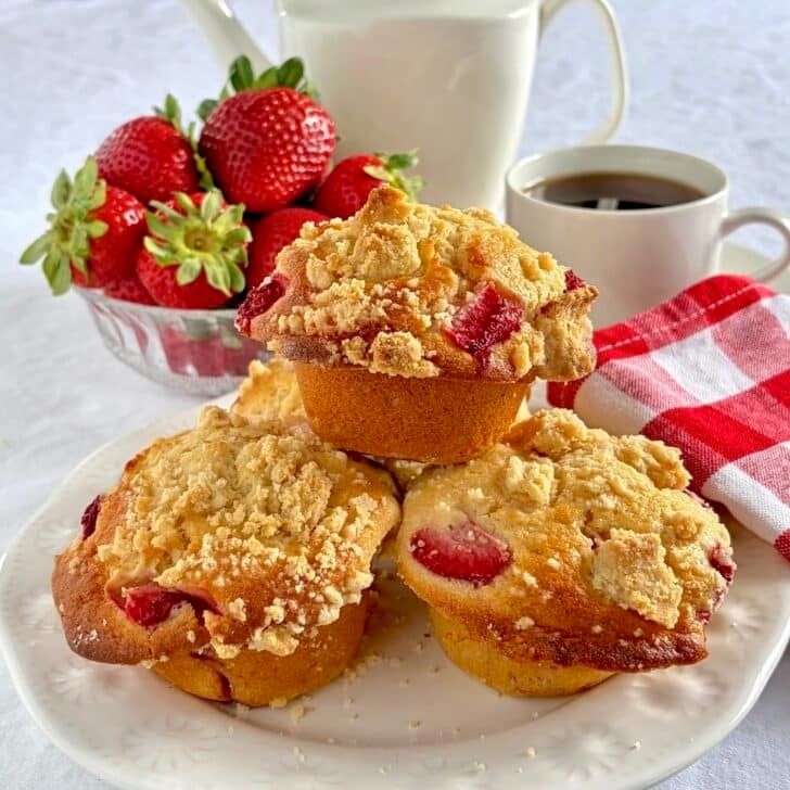 Strawberry Muffins with Shortbread Crumble close up photo of muffins on a white plate.
