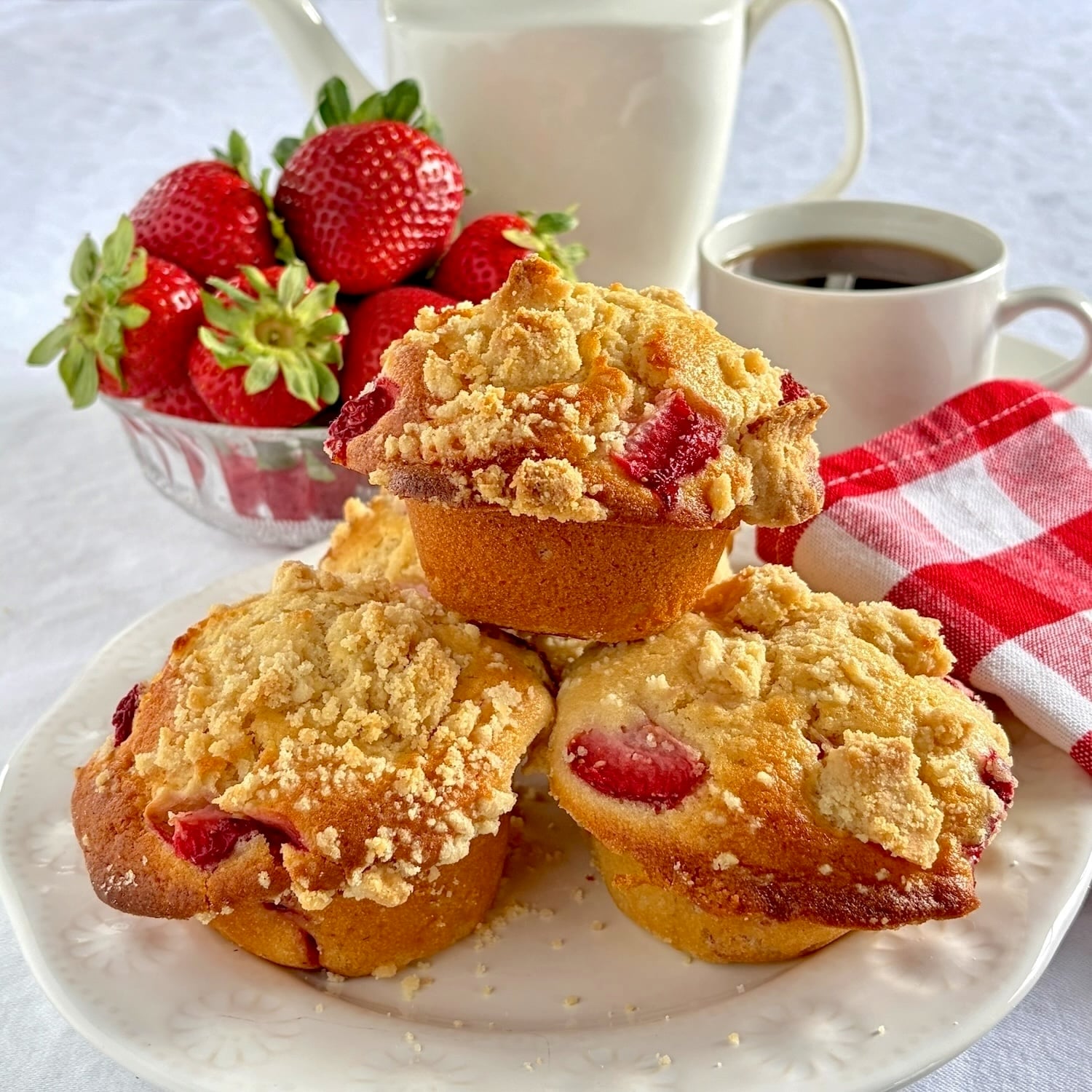 Strawberry Muffins with Shortbread Crumble close up photo of muffins on a white plate.