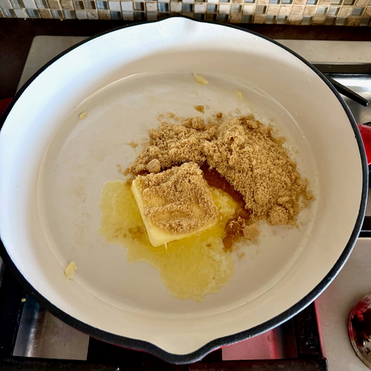 Butter and brown sugar in an enamelled skillet.