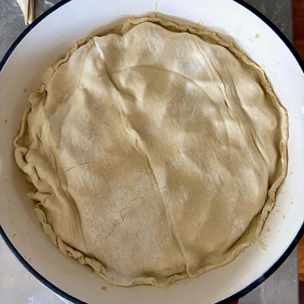Pastry fitted over the apple slices.