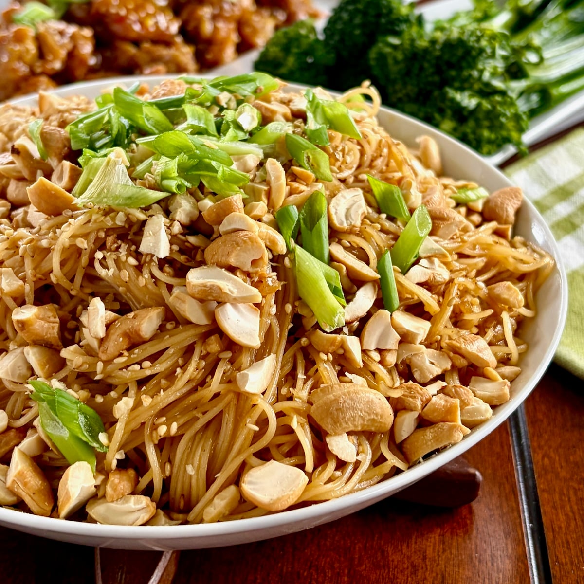 Sesame Garlic Noodles with Cashews photo of on noodles in a white serving bowl for featured image.