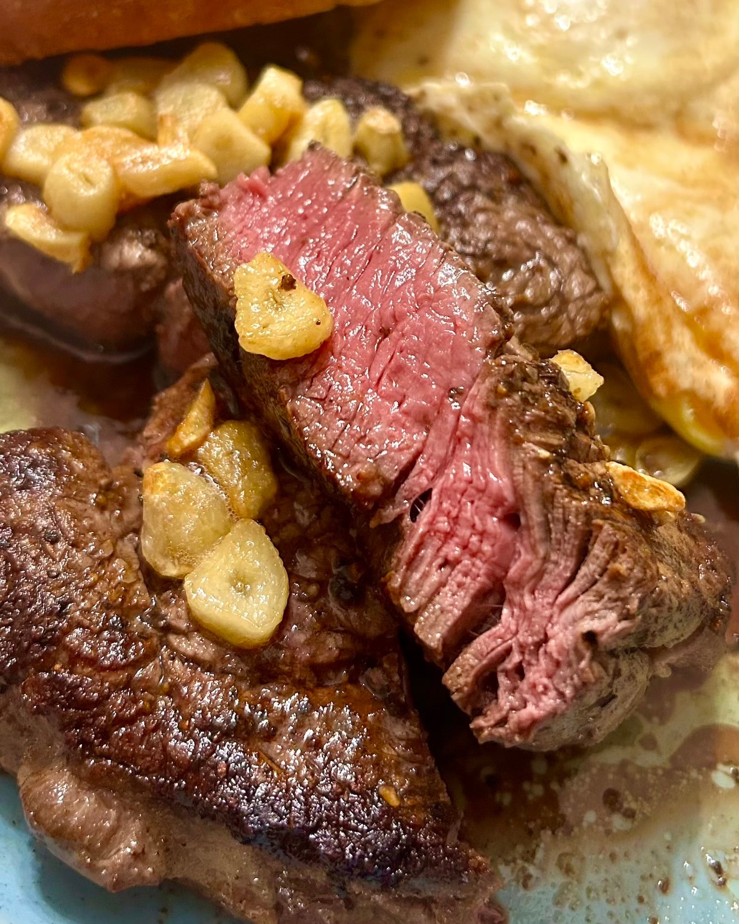 photo of poached garlic in prime rib steak