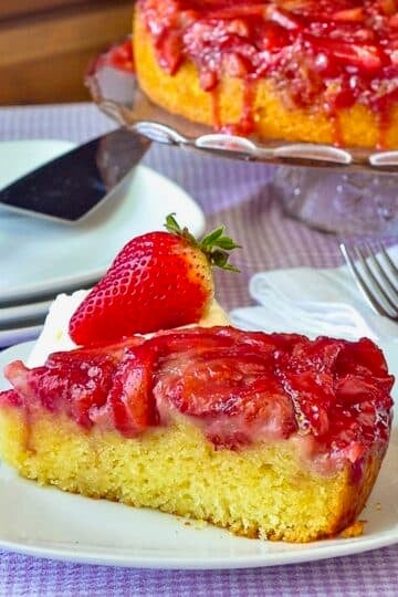 Strawberry Upside Down Cake photo if a single slice on a white plate.