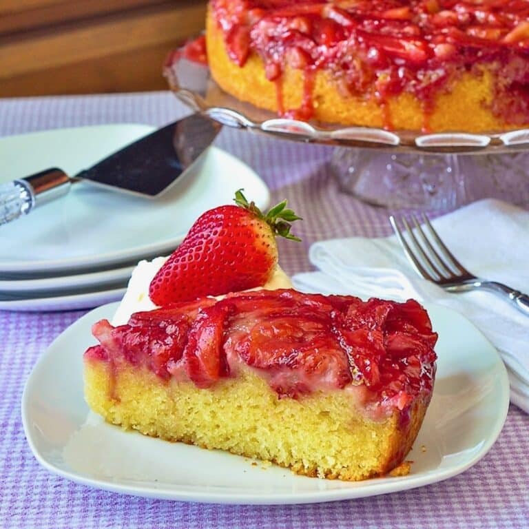 Strawberry Upside Down Cake photo if a single slice on a white plate.