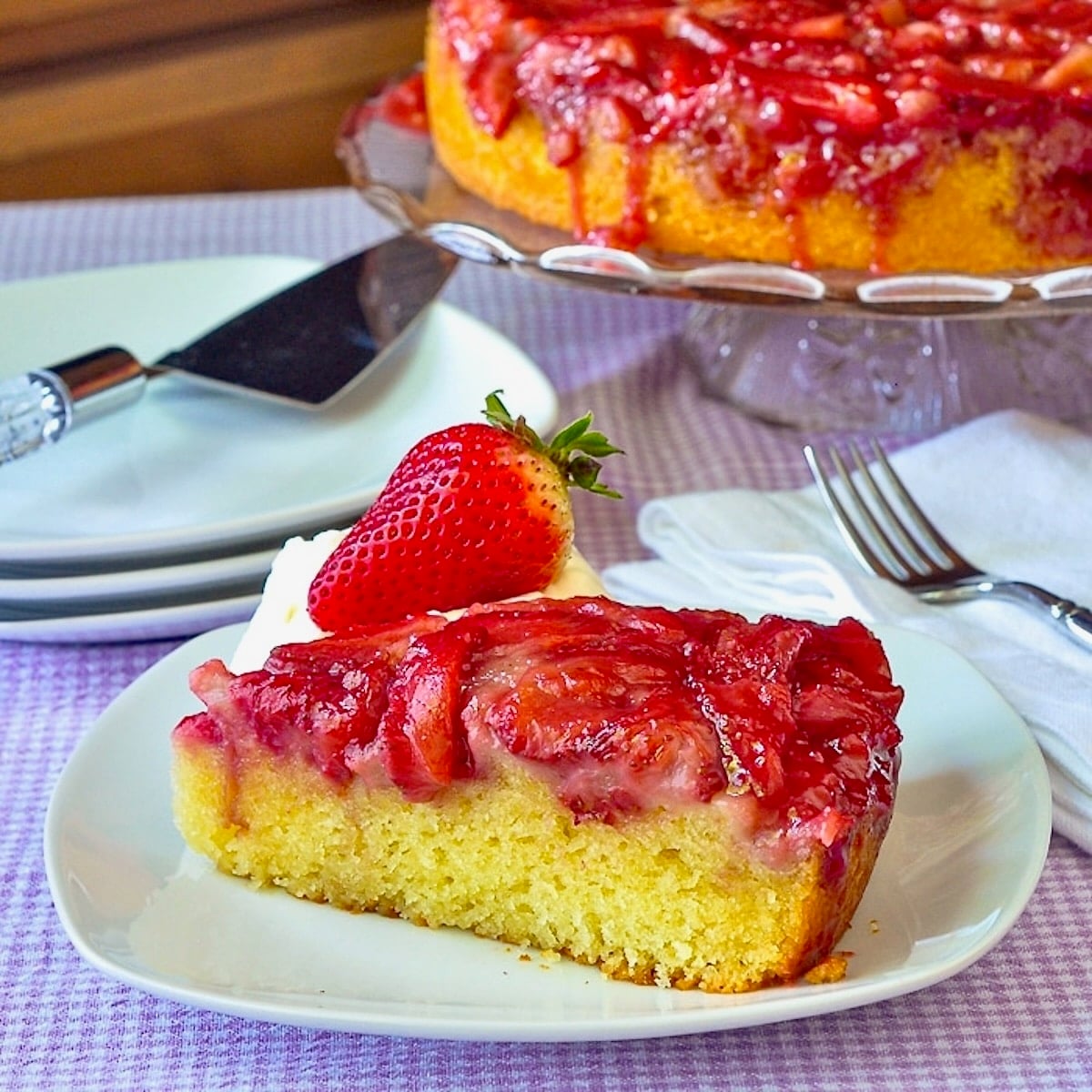 Strawberry Upside Down Cake photo if a single slice on a white plate.